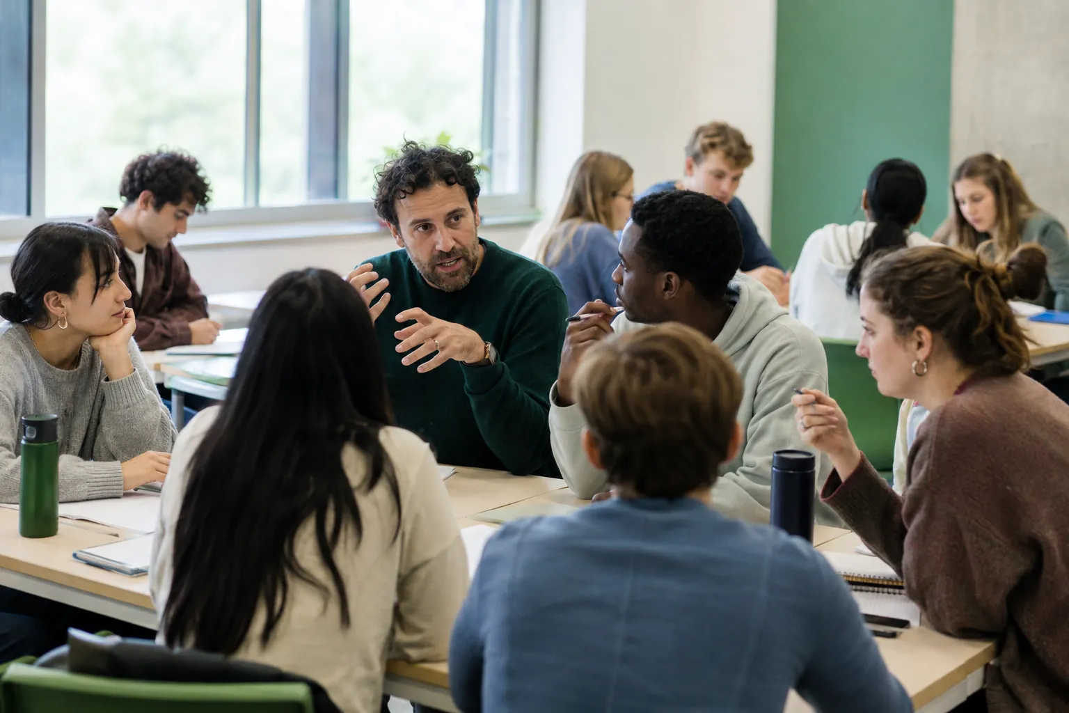 A teacher facilitating discussion with a diverse class
