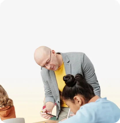 A teacher starting a lesson on a phone while students work
